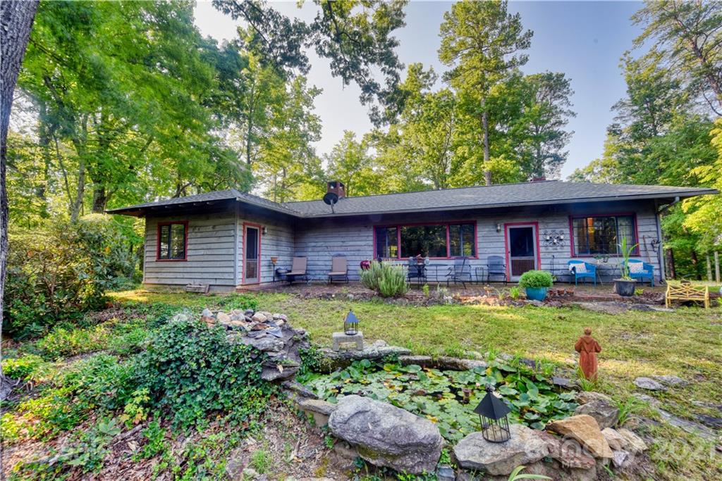 528 Wilderness Road Tryon, NC 28782 - Photo 7 of 29 a front view of house with yard and outdoor seating