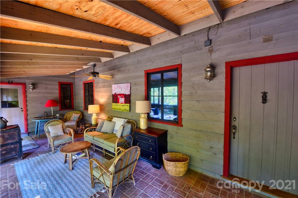 528 Wilderness Road Tryon, NC 28782 - Photo 10 of 29 a outdoor living space with furniture and a potted plant