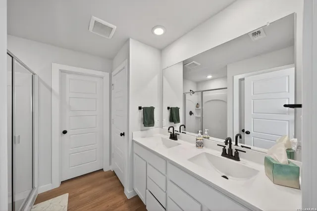 a bathroom with a double vanity sink mirror and double