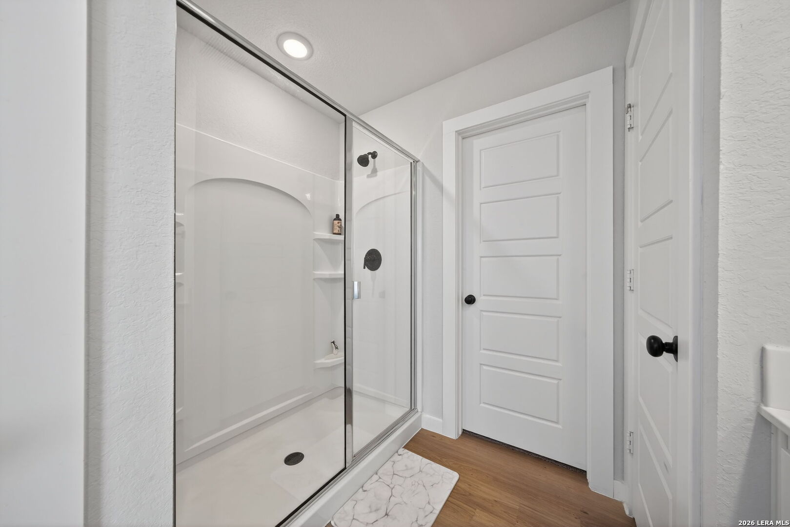 4238 Danforth Street New Braunfels, TX 78130 - Photo 13 of 21 a bathroom with a glass shower door