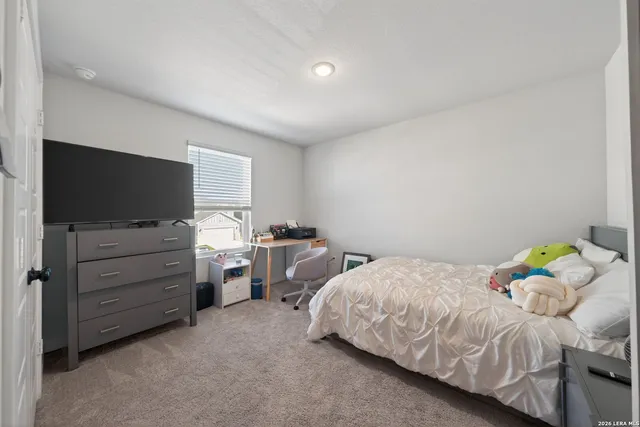 a bedroom with a bed and flat screen tv