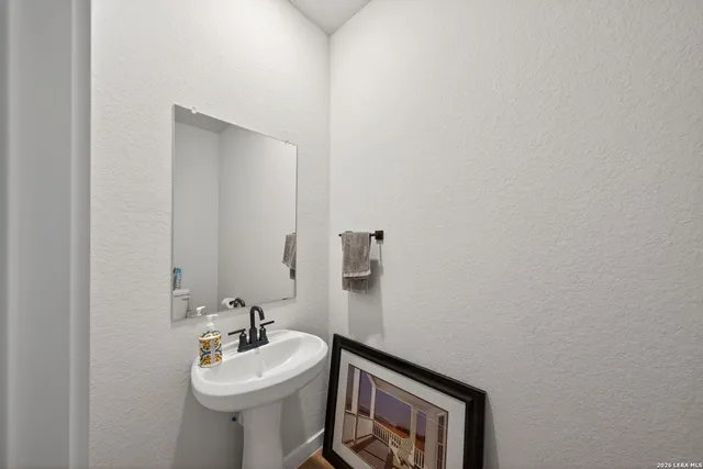 a bathroom with a sink mirror and toilet