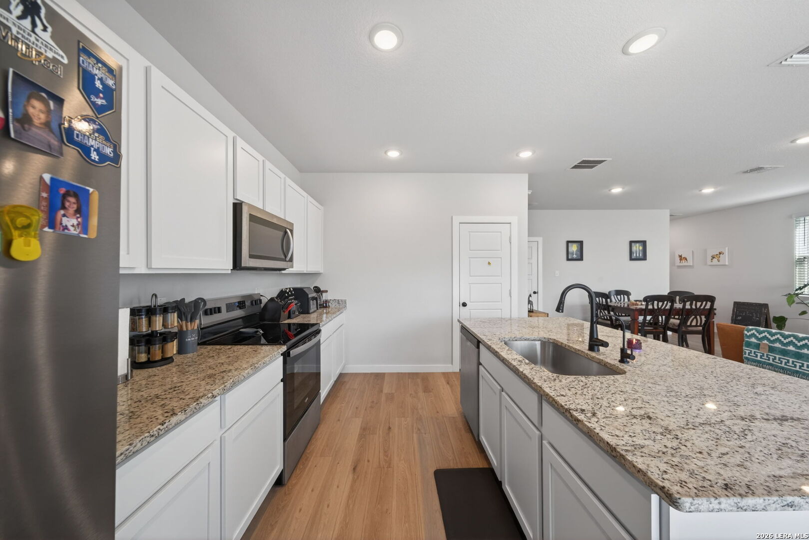 4238 Danforth Street New Braunfels, TX 78130 - Photo 8 of 21 a kitchen with granite countertop a sink a counter top space stainless steel appliances and cabinets