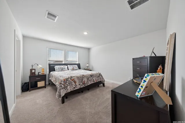 a bedroom with a bed and a tv