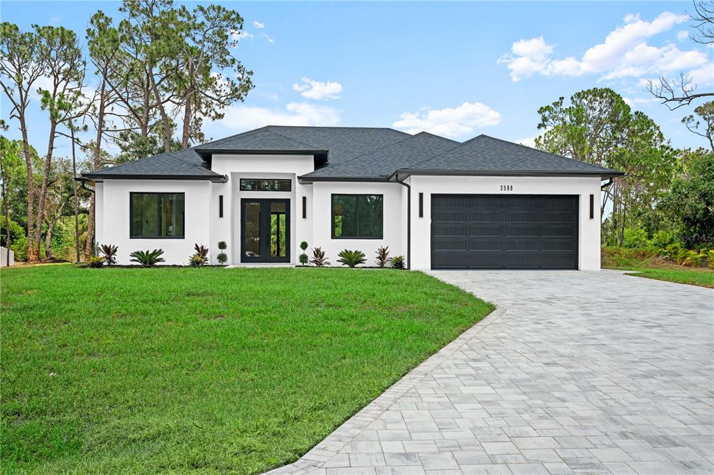 a front view of house with yard and green space