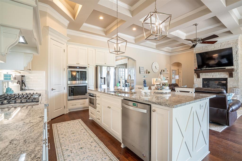 1920 Meander Road Granbury, TX 76049 - Photo 13 of 40 Gourmet kitchen featuring white cabinetry, stainless steel appliances, granite countertops, and a subway tile backsplash