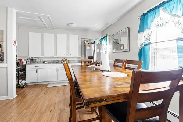 a dining room with furniture and wooden floor
