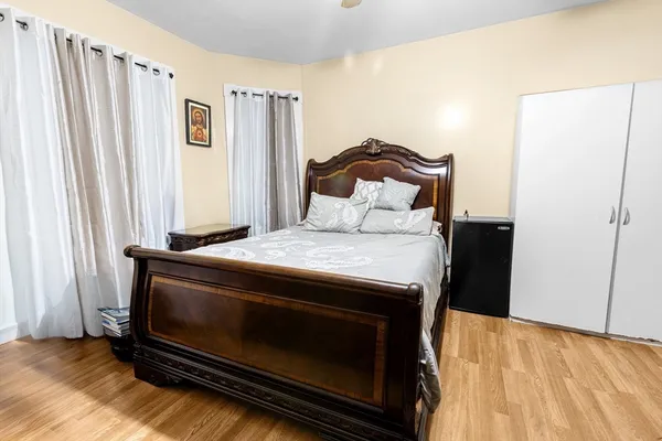 a bedroom with a bed and a window