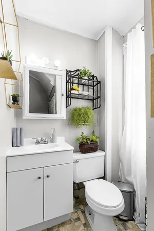 a bathroom with a toilet sink and mirror