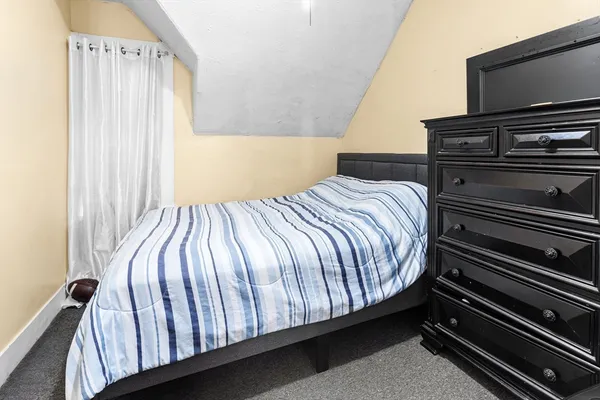 a bedroom with a bed and a flat tv screen