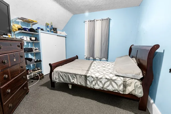 a bedroom with a bed and a closet