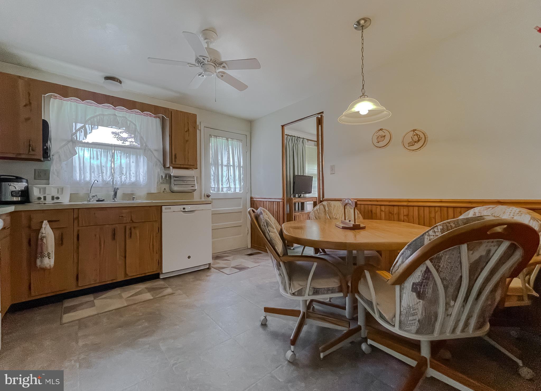 2422 Pinefield Road Waldorf, MD 20601 - Photo 11 of 43 a dining room with a sink a window and chairs