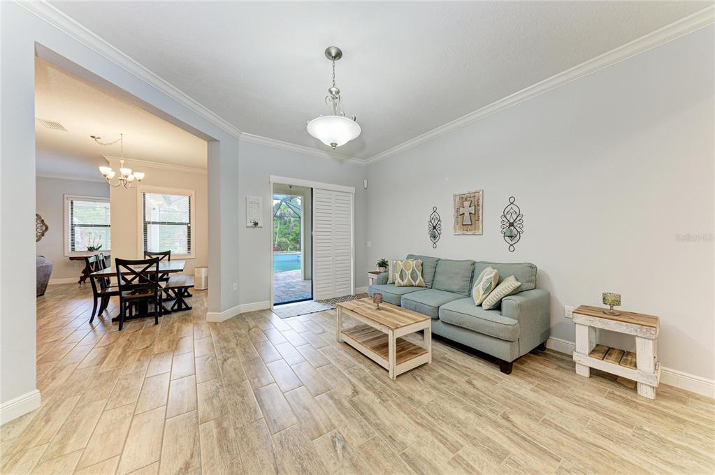 12642 Harney Street Venice, FL 34293 - Photo 9 of 85 a living room with furniture and a wooden floor