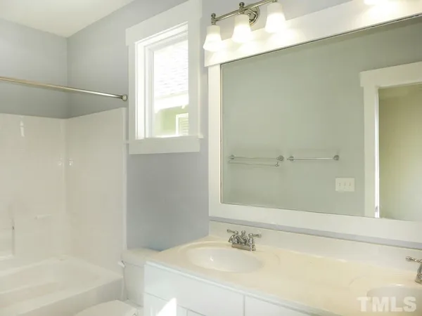 a bathroom with a bathtub and a sink