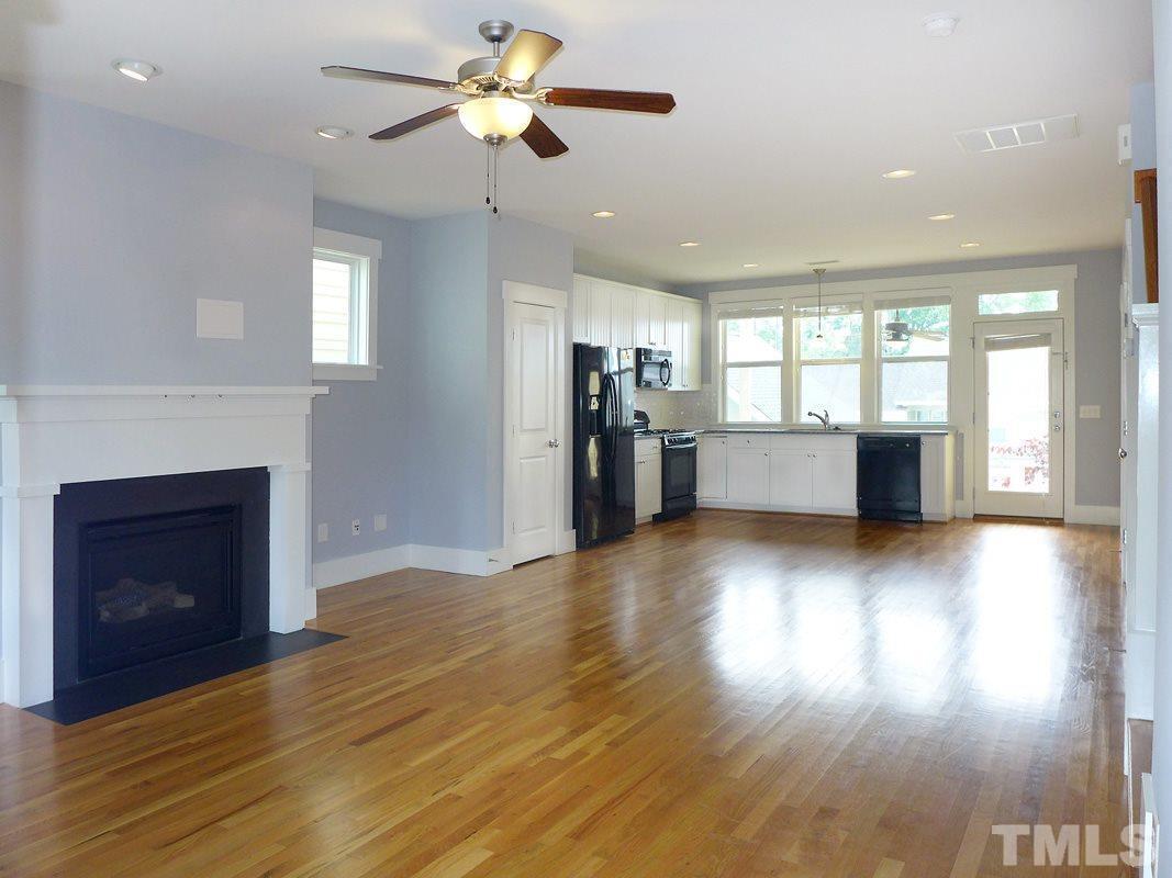 74 Owen Towne Road Chapel Hill, NC 27516 - Photo 4 of 27 an empty room with wooden floor a fireplace and windows