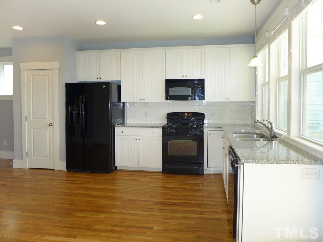 74 Owen Towne Road Chapel Hill, NC 27516 - Photo 9 of 27 a kitchen with stainless steel appliances a refrigerator sink and cabinets