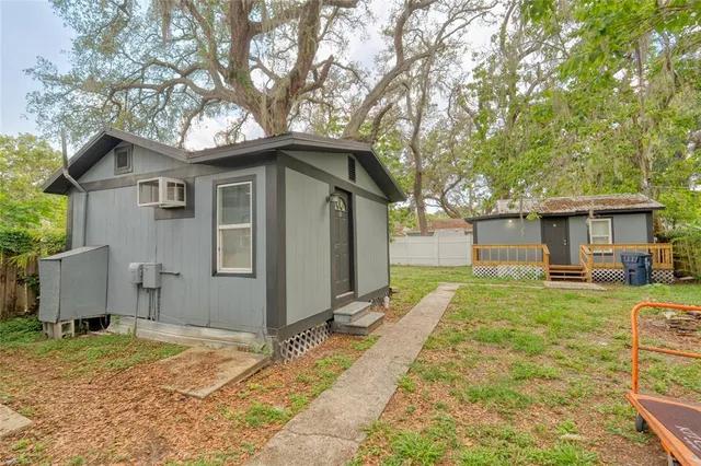 a front view of a house with a yard and trees
