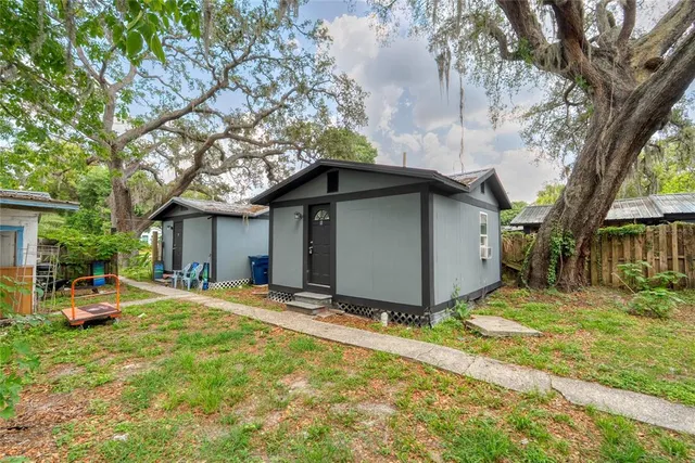 a front view of house with yard and trees around