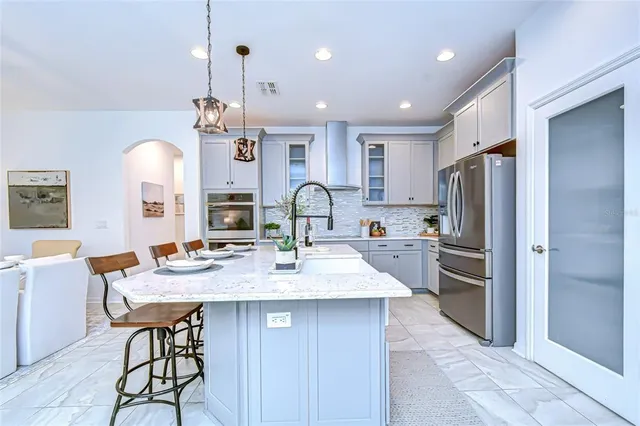 a large kitchen with a table and chairs