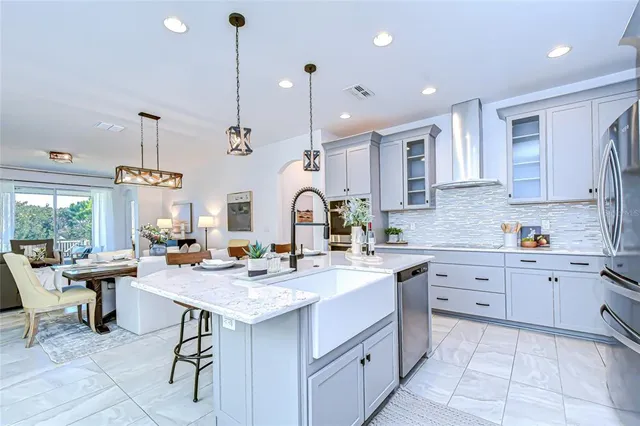 a kitchen with sink stove and cabinets