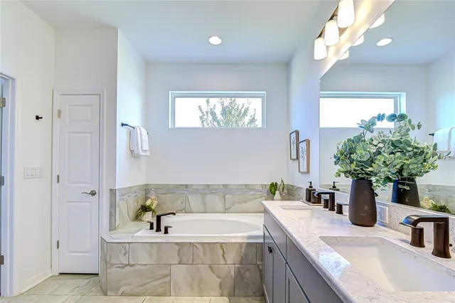a bath tub sitting in a bathroom next to a sink