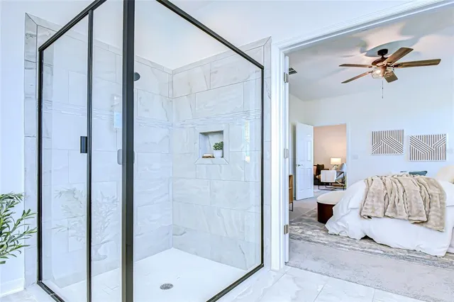 a en suite bathroom with a shower and a mirror