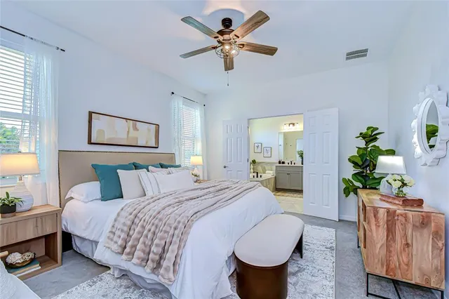 a bedroom with a bed and a chandelier