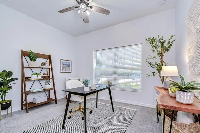 a workspace with furniture and a potted plant