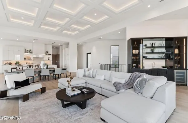 a kitchen with a stove a refrigerator and chairs