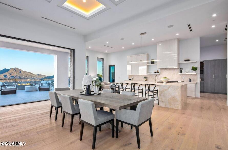 4880 East Lone Mountain Road North Cave Creek, AZ 85331 - Photo 15 of 73 a view of a dining room with furniture and wooden floor