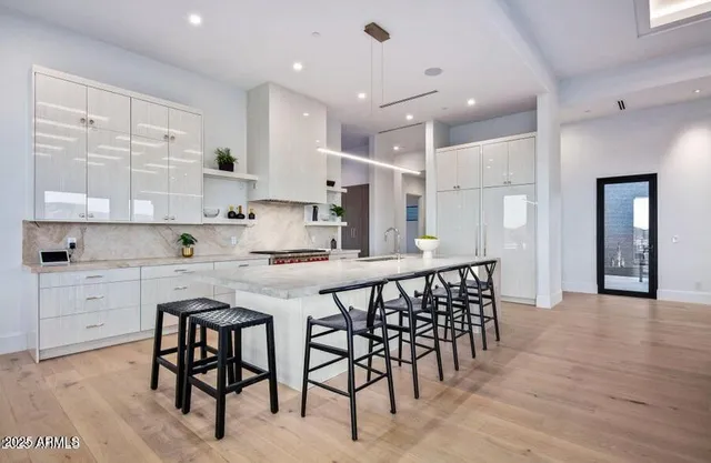 a kitchen with a refrigerator and a sink