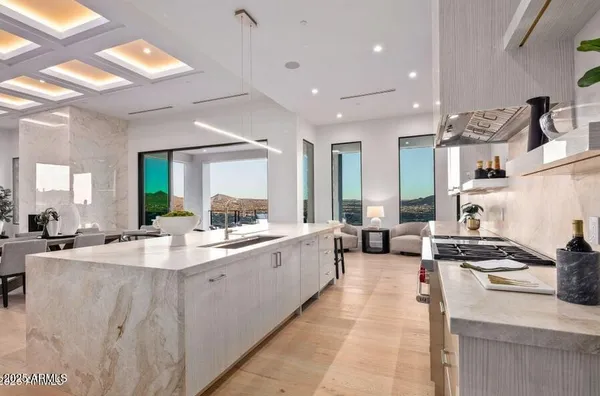 a kitchen with stainless steel appliances a sink stove and cabinets