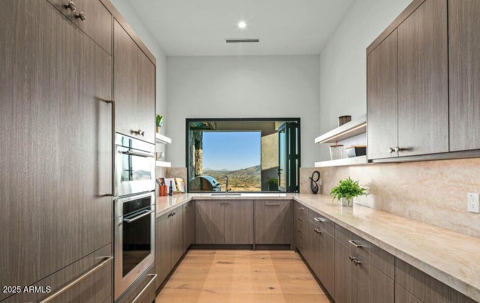 4880 East Lone Mountain Road North Cave Creek, AZ 85331 - Photo 23 of 73 a kitchen with stainless steel appliances a sink stove and cabinets