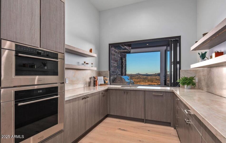 4880 East Lone Mountain Road North Cave Creek, AZ 85331 - Photo 24 of 73 a kitchen with a sink stove and microwave