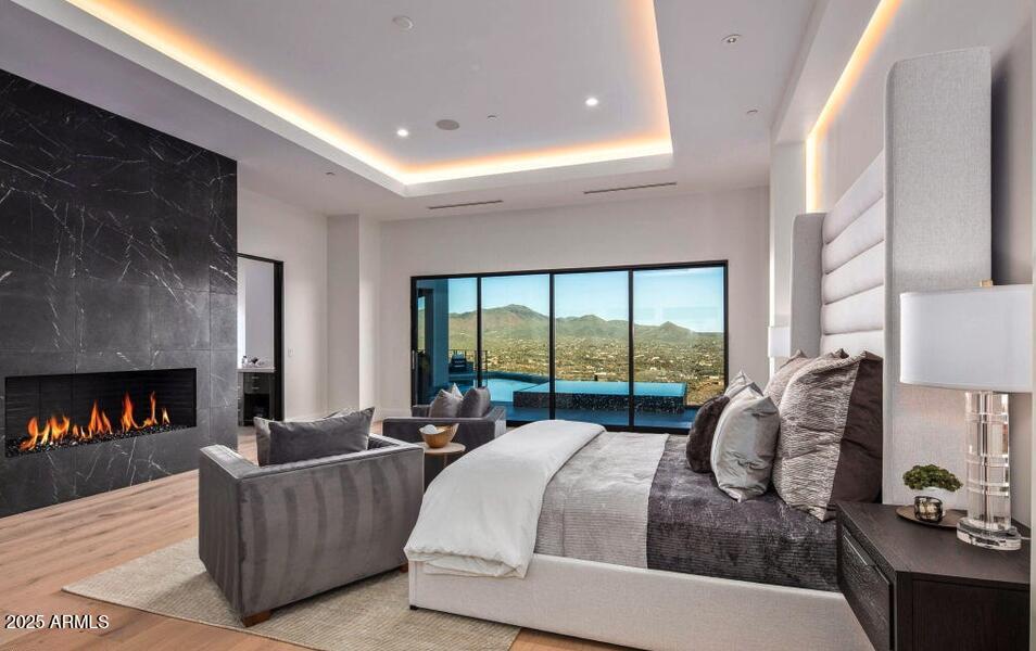 4880 East Lone Mountain Road North Cave Creek, AZ 85331 - Photo 38 of 73 a bed room with a bed and a fireplace