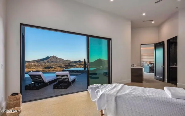 a bedroom with a large bed and a large window