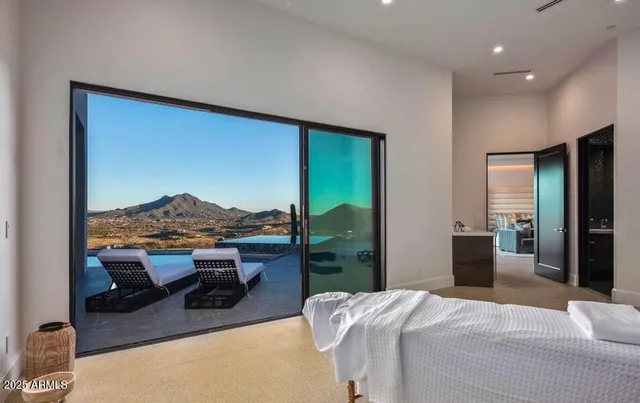 a bedroom with a large bed and a large window