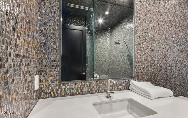 a living room with furniture and painting on the wall