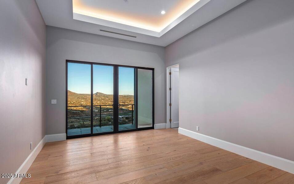 4880 East Lone Mountain Road North Cave Creek, AZ 85331 - Photo 58 of 73 an empty room with wooden floor and balcony