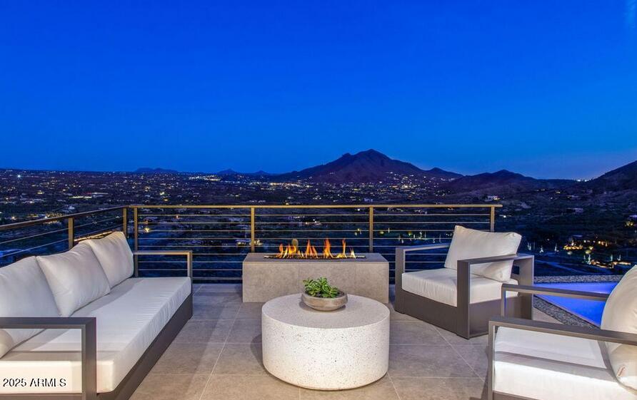 4880 East Lone Mountain Road North Cave Creek, AZ 85331 - Photo 7 of 73 a view of a balcony with couches and wooden floor