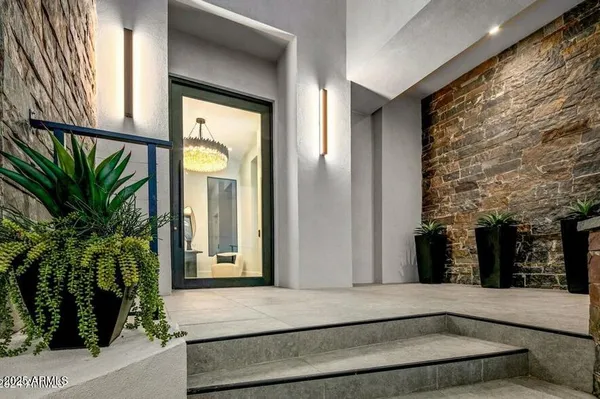 a living room with furniture a fireplace and a large window