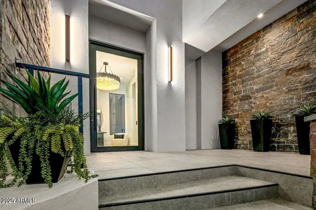 a living room with furniture a fireplace and a large window