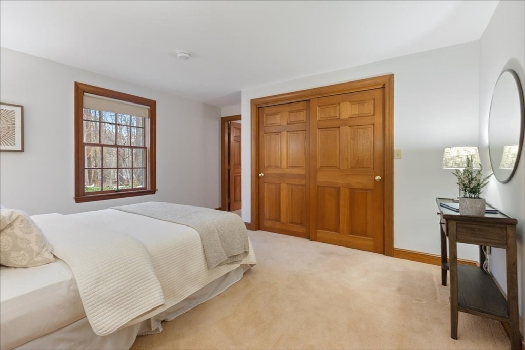 86 Dodges Row Wenham, MA 01984 - Photo 14 of 40 a spacious bedroom with a bed and a table in it