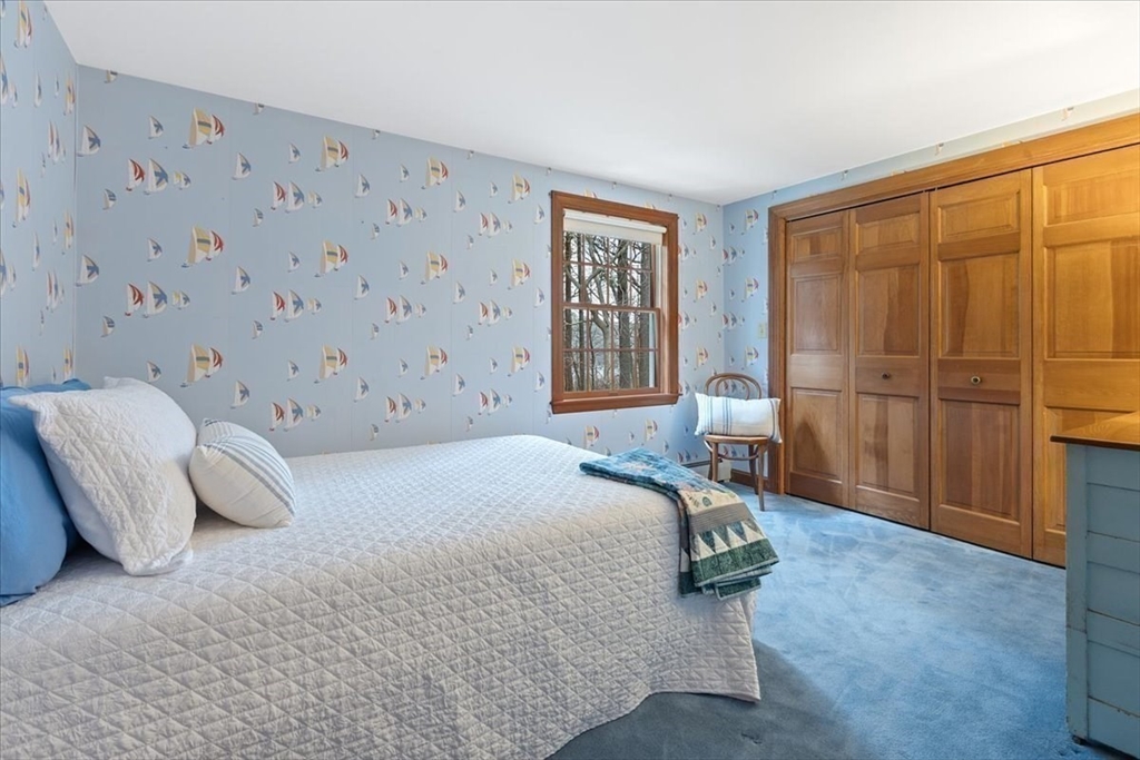 86 Dodges Row Wenham, MA 01984 - Photo 22 of 40 a bedroom with a bed and a cabinets