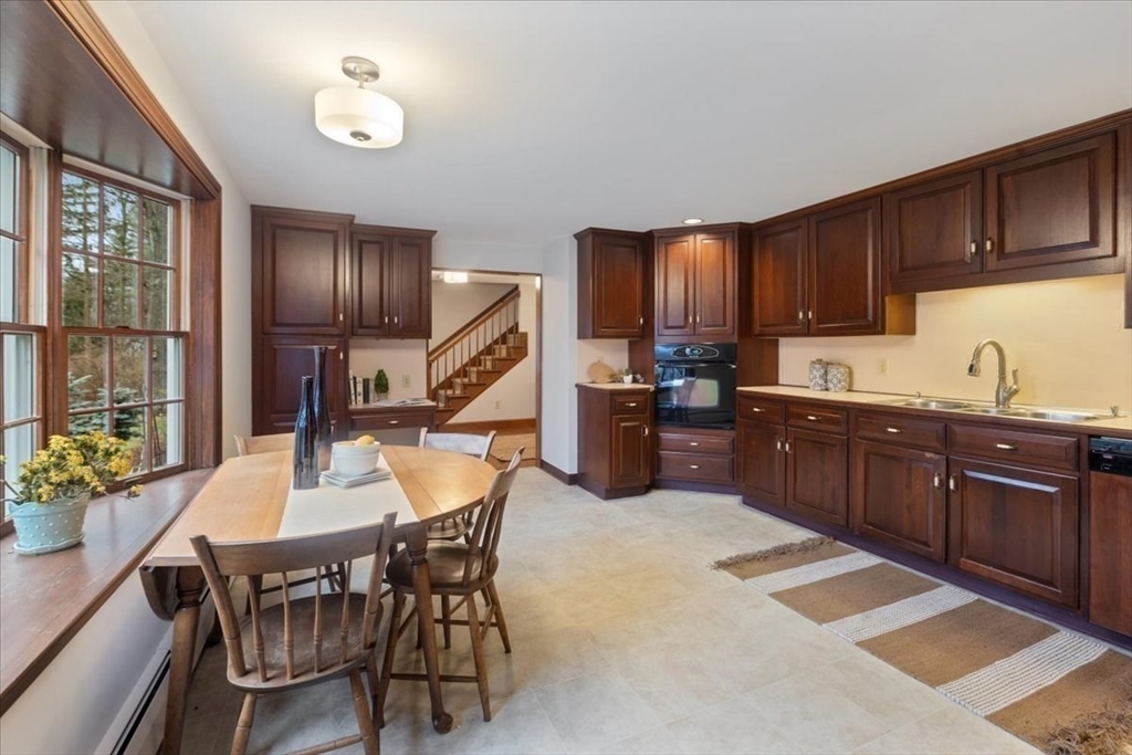 86 Dodges Row Wenham, MA 01984 - Photo 10 of 40 a kitchen with a dining table and chairs