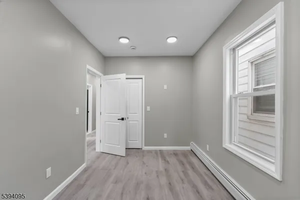 a view of a livingroom with wooden floor and window