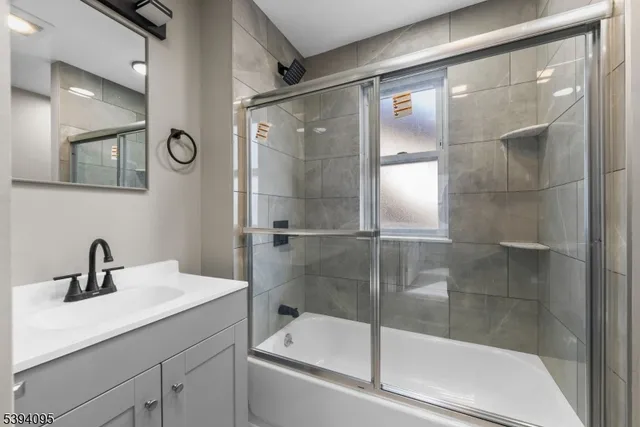 a bathroom with a shower and a sink