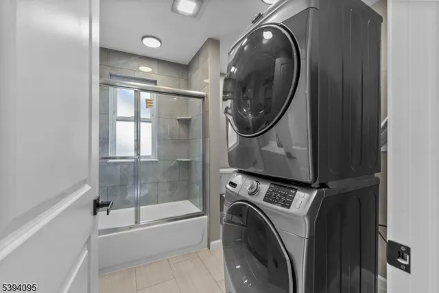 a view of a bathroom with washing machine and dryer