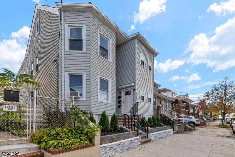 1033 East 23rd Street, Unit 2 Paterson, NJ 07513 - Photo 2 of 21 a front view of a house with garden