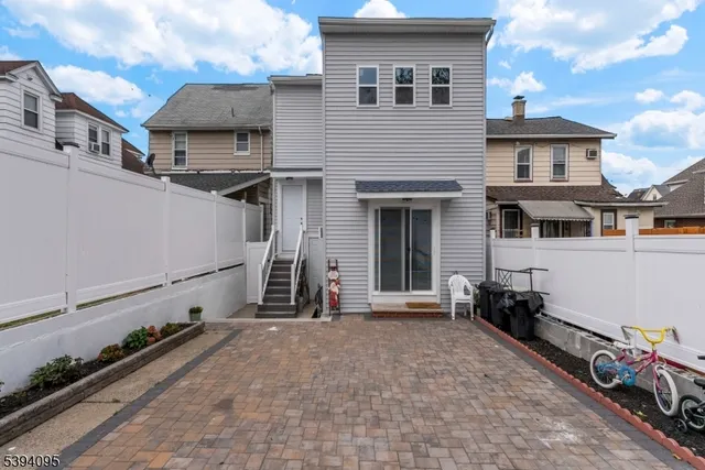 a view of a house with a wooden fence